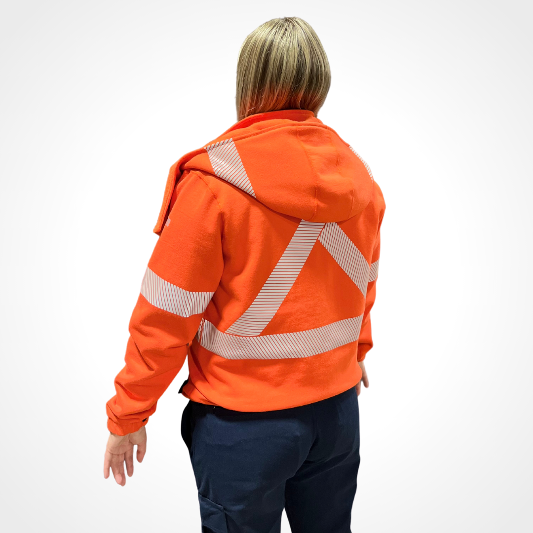 MWG BLOCKER Women's FR Hoodie. Women's FR Hoodie is bright orange with silver segmented reflective tape on torso, sleeves, and back for high-visibility. MWG BLOCKER is an inherent heavyweight flame-resistant fleece. Image displays X on back for high-visibility on FR Hoodie.