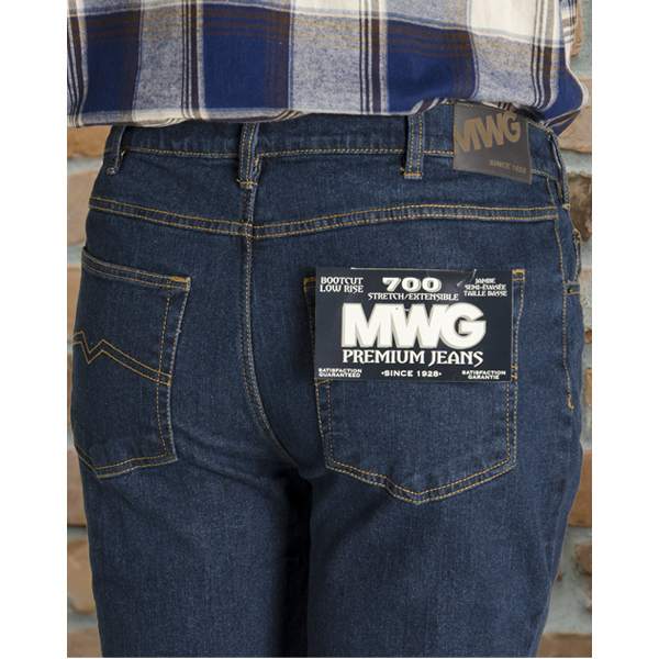 Image of MWG Jeans. MWG Premium Stretch Bootcut Jeans are dark blue in colour with gold stitching. Brown leather MWG label is seen on waistband.