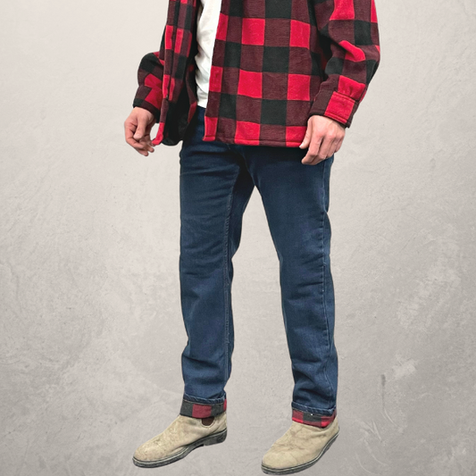 Image of MWG Flannel-Lined Stretch Denim Jeans. MWG Flannel Jeans are navy with a red and black flannel lining. Model is wearing MWG Flannel Lined Jeans with an MWG Red and Black Flannel Shirt.