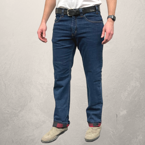 Image of MWG Flannel-Lined Men's Stretch Jean. MWG Flannel-Lined Jean is navy with a red and black flannel lining. Model is wearing MWG Jeans with the cuffs rolled to display flannel lining. Flannel lined jeans have 7 belt loops and pockets on hips and butt.