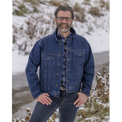 Image of MWG Storm Rider jean jacket. Storm Rider jacket is navy in colour with gold stitching and buttons. Jacket has two large chest pockets. Model is wearing MWG Storm Rider Jacket with collar up, over a blue and black MWG snap flannel shirt.