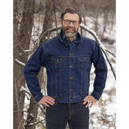 Image of MWG Storm Rider Men's Denim Jacket. MWG Men's Jean Jacket is navy in colour with gold stitching and gold buttons. Denim jacket has two large chest pockets and two side slant pockets on hips. Model is wearing Storm Rider Jacket with the collar up and MWG stretch denim blue jeans for bottoms.