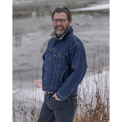Image of MWG Storm Rider Lined Denim Jacket. MWG jean jacket is navy in colour with gold stitching and a tan corduroy collar. Model is wearing the collar up. Model is wearing Storm Rider Lined Denim Jacket with MWG stretch denim blue jeans.