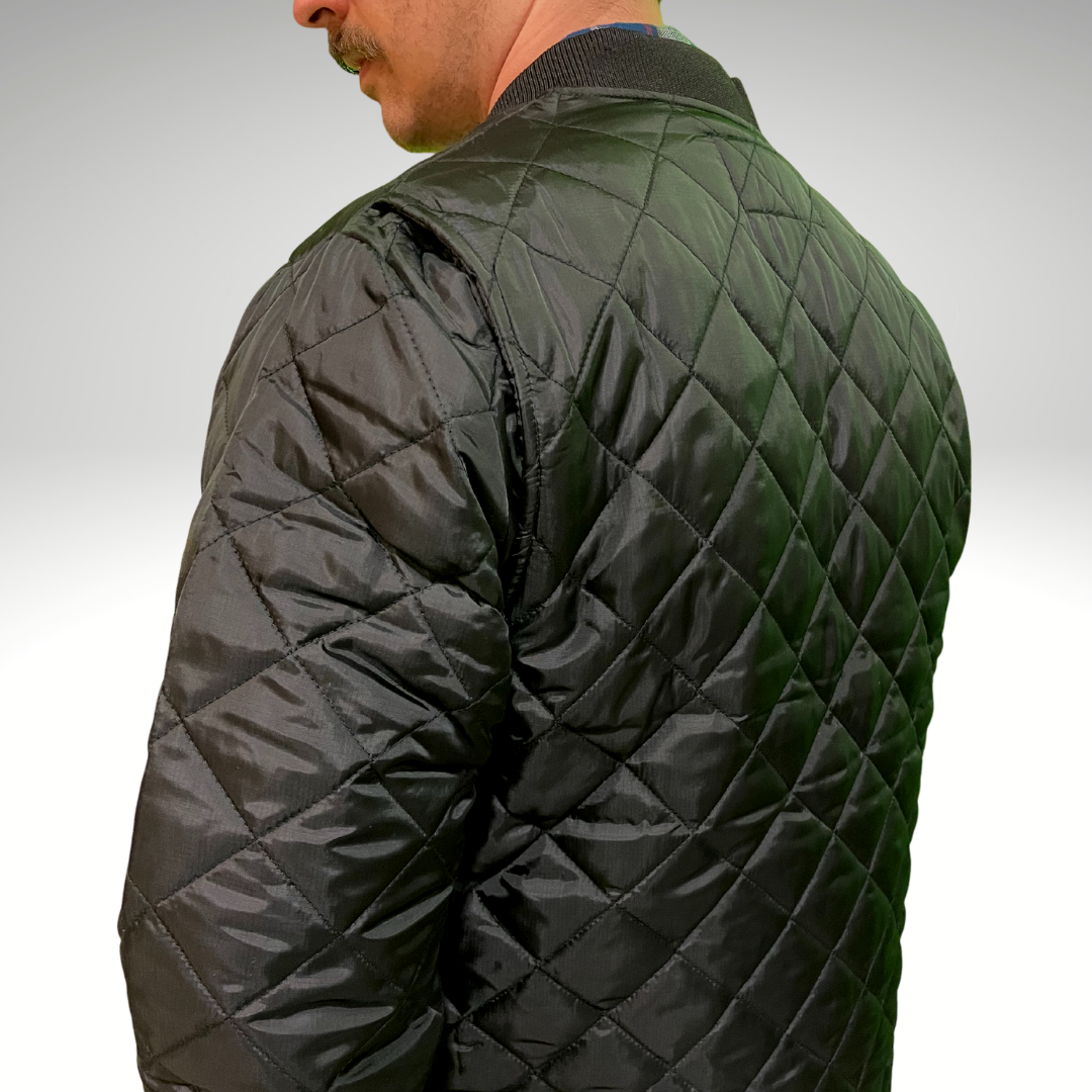 Image of MWG Men's Ripstop Freezer Jacket. MWG Freezer Jacket is all black with a 3" diamond quilt. Freezer Jacket is made with a ripstop fabric for durability. Ripstop Freezer Jacket has a ribbed collar and an action back for ease of movement.
