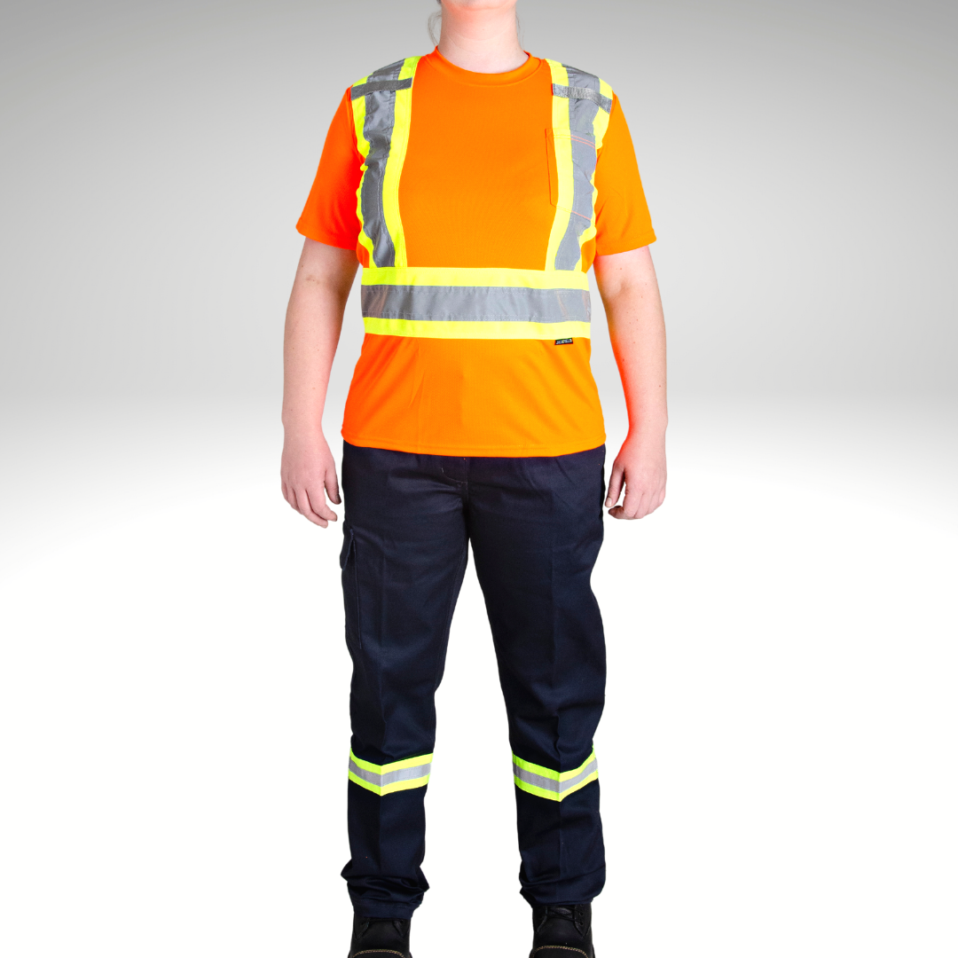 Image of MWG Women's Hi-Vis Short Sleeve T-Shirt. Women's Hi-Vis T-Shirt is bright orange with yellow/silver/yellow reflective tape on torso. Left chest has a pocket and both shoulder have a radio clip. Model is wearing MWG Hi-Vis shirt with women's hi-vis cargo pants.